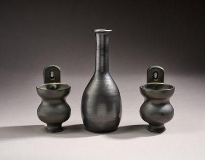 three vases sitting next to each other on a table