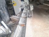 a machine that is working on a piece of wood