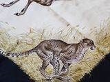two cheetah and a cheetah running in the grass