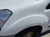 a small white van parked on the side of the road