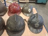 many helmets that are sitting on a table