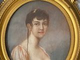 painting of a woman in a pink dress in a gold frame