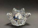 a glass frog figurine sitting on a table