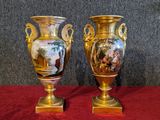 two vases that are sitting on a red table