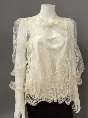 a mannequin mannequin wearing a white blouse and black skirt