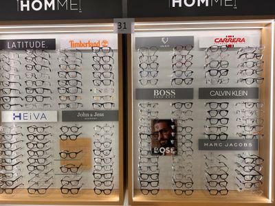 many glasses on display in the window of a store