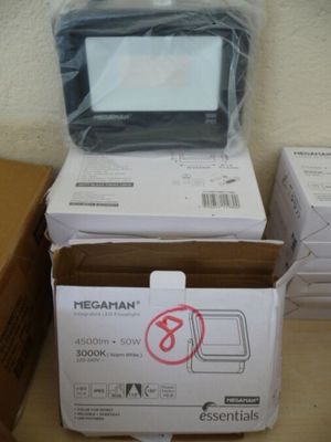 plusieurs cartons contenant du matériel électronique posés sur une table en bois