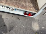 a red object sitting on the ground next to a door