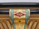 a close up of a gold and green vase with a sign on it