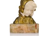 statue of a woman with a gold headdress on a wooden block