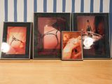 three framed pictures of a woman on a shelf