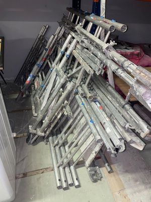 a lot of baseball bats stacked up in a room