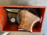 a red box with a clock and other items in it