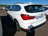 a white bmw suv parked in a parking lot