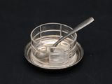a glass cup with a spoon in it on a saucer