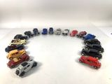 many toy cars arranged in a circle on a table