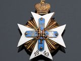 a close up of a cross with a crown on top of it