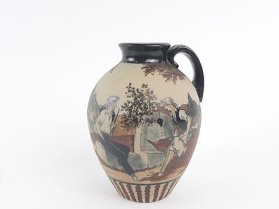 a vase with a painting on it sitting on a table