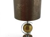 a close up of a lamp on a table with a brown shade