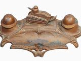 an old brass plate with a baseball and glove on top of it