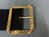 a close up of a belt with a gold buckle on it