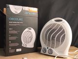 a white fan sitting on top of a wooden table next to a box