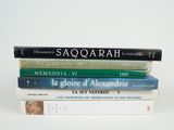 several books stacked on top of each other on a white surface