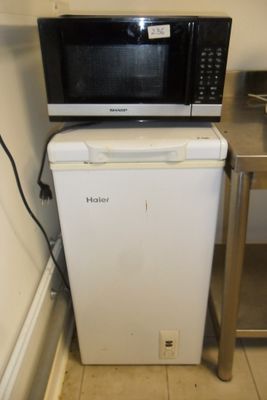 a microwave sitting on top of a refrigerator in a kitchen