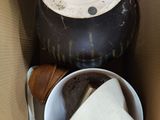 a cup of coffee in a cardboard box with a lid