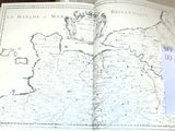 an open book with a map on it sitting on a table