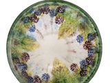 a picture of a glass bowl with grapes on it