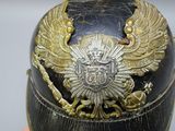 a close up of a helmet with a coat of arms on it