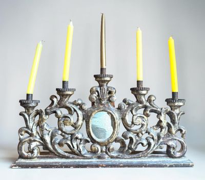 a silver and gold menorat with four candles on it