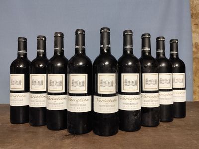 six bottles of wine are lined up in a row on a table