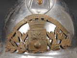 a silver helmet with a crest and a crown on it