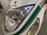 a close up of a motorcycle with a green and white stripe on it