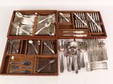 a wooden tray with silverware in it on a white surface