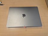 a silver apple laptop sitting on a wooden desk