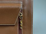 a close up of a brown bag with a zipper on it