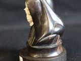 a statue of a person with a hood on it