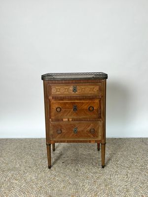 une ancienne commode en bois avec un plateau en marbre