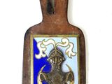 a wooden plaque with a blue and gold design on it