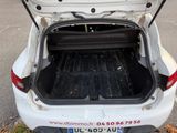 a white car with its trunk open in a parking lot