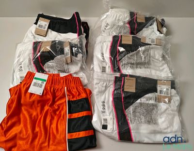 two pairs of orange and black boxer shorts sitting next to each other