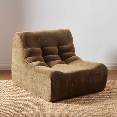 the brown chair is sitting on the carpet in the room