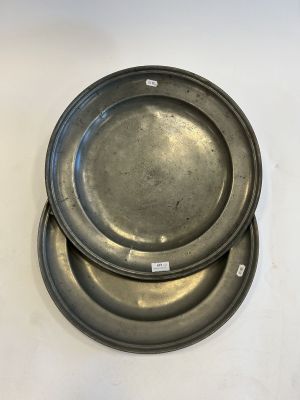 three metal plates sitting on top of each other on a white surface