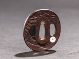 a close up of a japanese coin with a hole in the middle