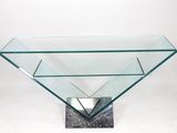 a glass table with a metal base and a square glass top