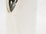 a white vase that has a cell phone in it