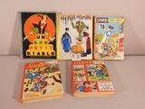 four comics are lined up on a table in front of a white wall